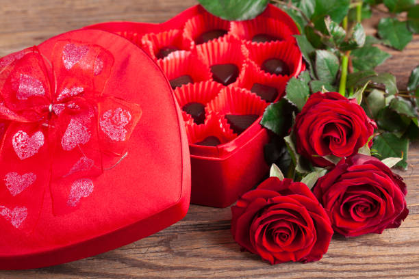 istock Heart chocolate box and red roses on wooden rustic background 1126001571