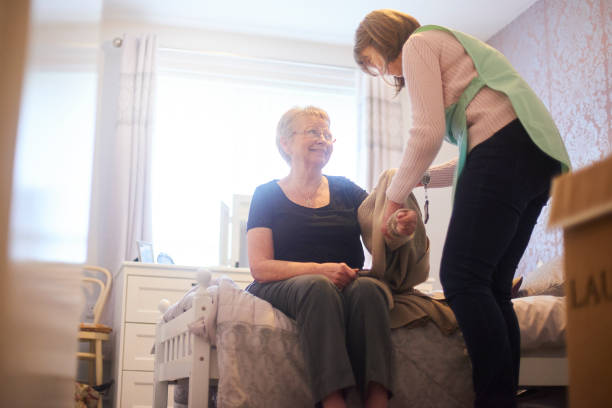 istock Helping senior woman get dressed 1126004829