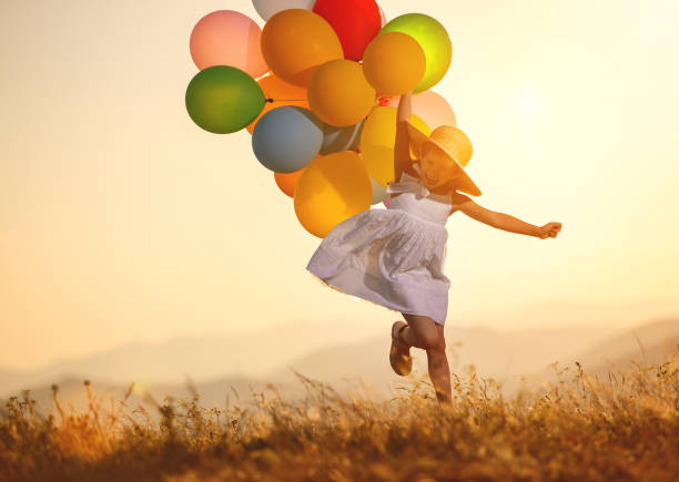 istock . happy child with balloons at sunset in summer 1126006879