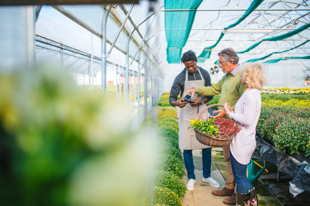 istock Senior couple making NFC payment in greenhouse 1126010361