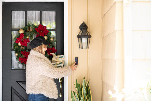 istock Woman With Gift Rings Doorbell 1126015238