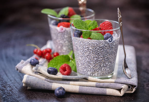 Chia seed pudding with fresh berries for the breakfast Two glasses of chia seed pudding with fresh berry fruits and mint topping for the breakfast Chia Pudding stock pictures, royalty-free photos & images