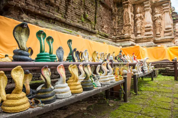 Photo of A lot of snake statue around the base of pagoda in Wat Jed Yod temple of Chiang Mai province of Thailand.