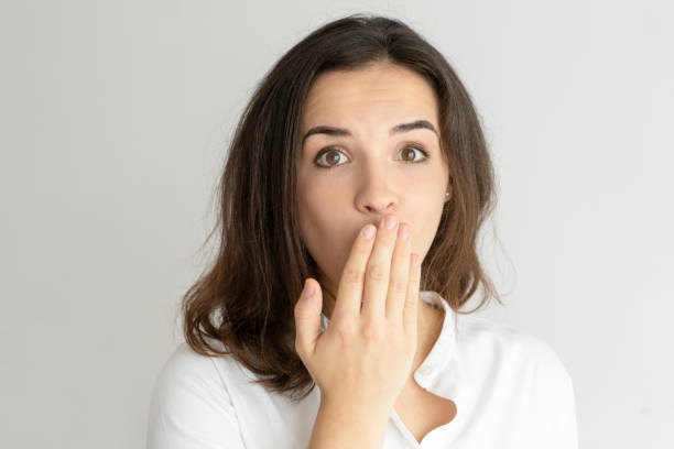 istock Embarrassed young woman covering mouth with hand 1126023151