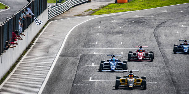 istock Formula race cars approaching the finish line 1126024289