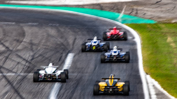 istock Blurred formula race cars on a race track 1126024291