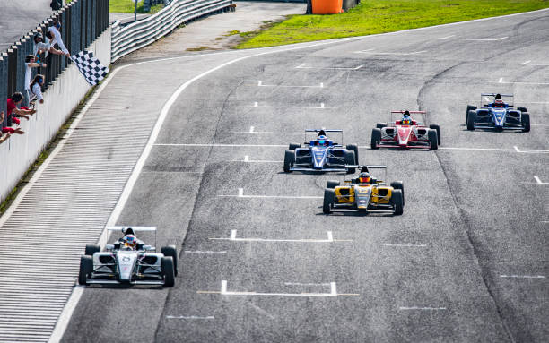 istock Formula race cars approaching the finish line 1126024298