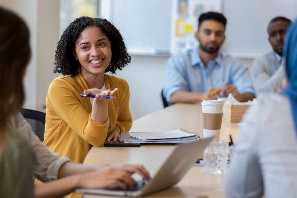 istock Female creative professional speaks during team meeting 1126024398