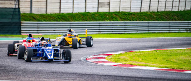 istock Formula race cars making a turn 1126025459