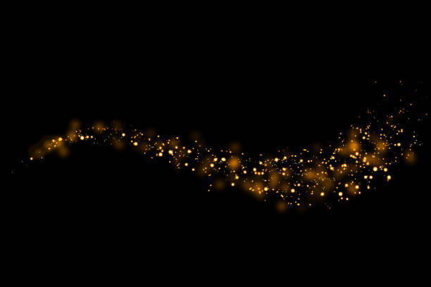 istock Gold glitter particles lights trail and bokeh on a black background. Abstract line sparkle texture. 1126027985