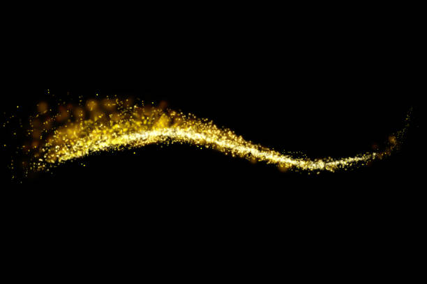 istock Gold glitter particles lights trail and bokeh on a black background. Abstract line sparkle texture. 1126027986