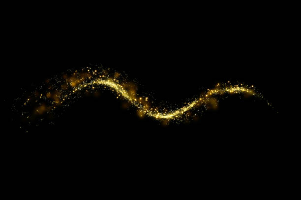 istock Gold glitter particles lights trail and bokeh on a black background. Abstract line sparkle texture. 1126028006