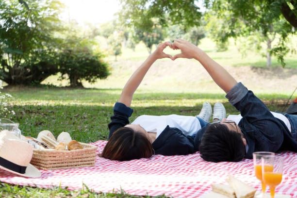 istock man woman lay on floor hand together 1126029267