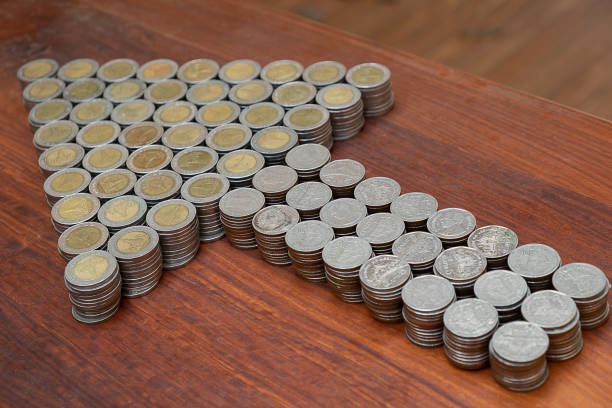 istock Thai Baht lots coin Arranged in arrow shape on with blurred background texture, Money stack for business planning investment and saving concept 1126030221