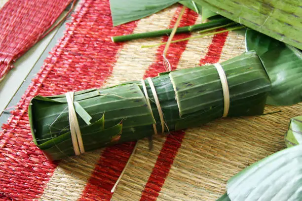 Photo of Vietnamese traditional cake for celebrating New Year from rice, meat and species wrapped in banana leaves - Tet cake.