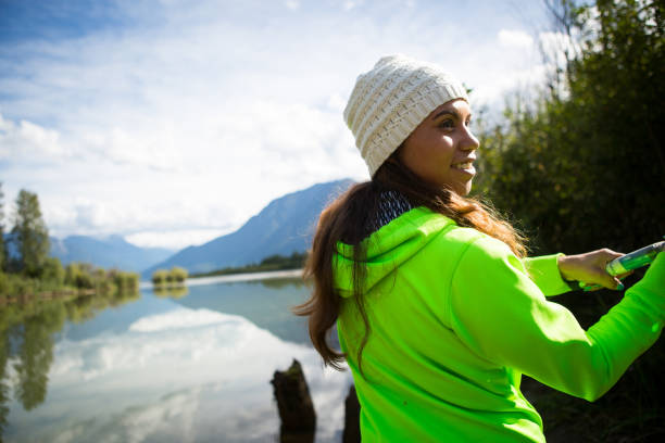 Indigenous Canadian woman fishing An indigenous Canadian woman standing by the river salmon fishing beautiful eskimo women stock pictures, royalty-free photos & images