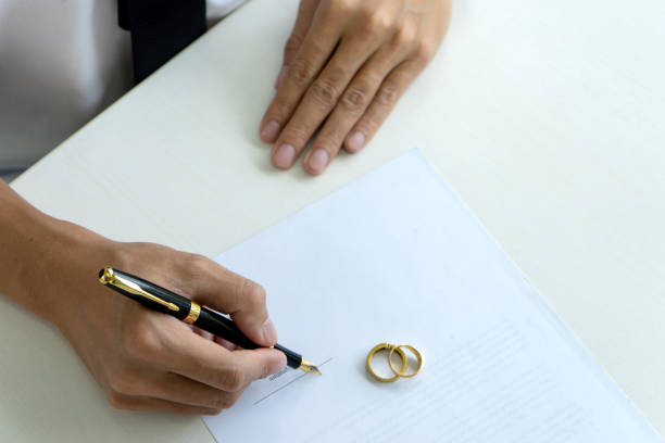 istock Hand man woman on paper with marry ring 1126032280