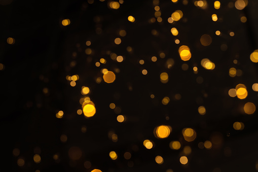 Gold glittering star light and bokeh. Abstract background.