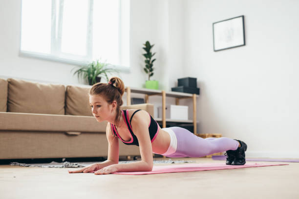 istock Fit girl doing plank exercise at home. 1126035472