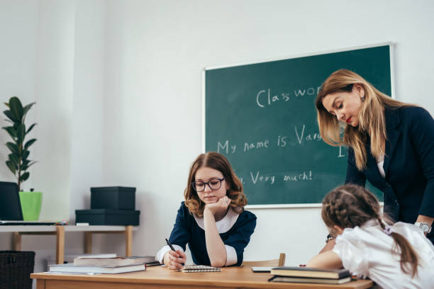 istock Education school lesson female teacher with pupils 1126036155