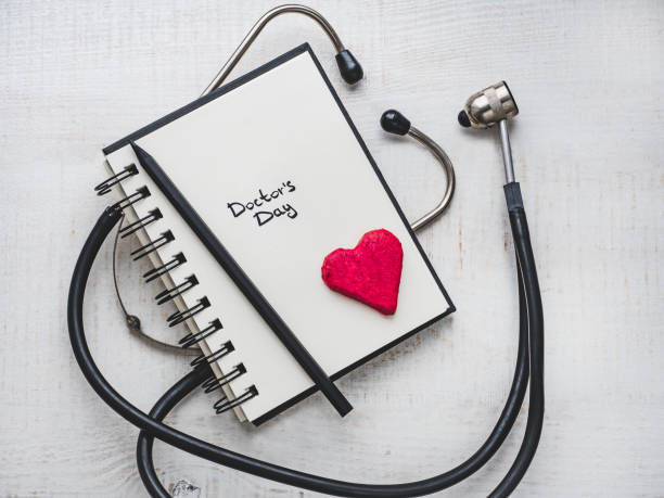 istock Happy Doctor's Day. Beautiful card. Notebook with congratulatory inscription 1126036430