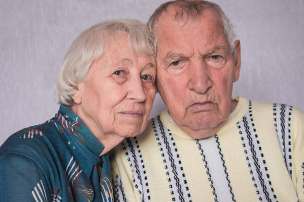 istock Romantic sad elderly couple sitting close together 1126038114