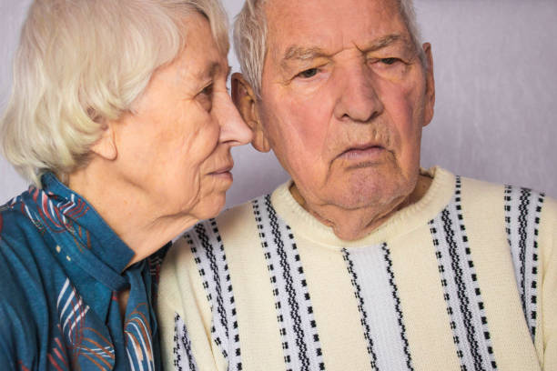 istock Romantic sad elderly couple sitting close together 1126038120