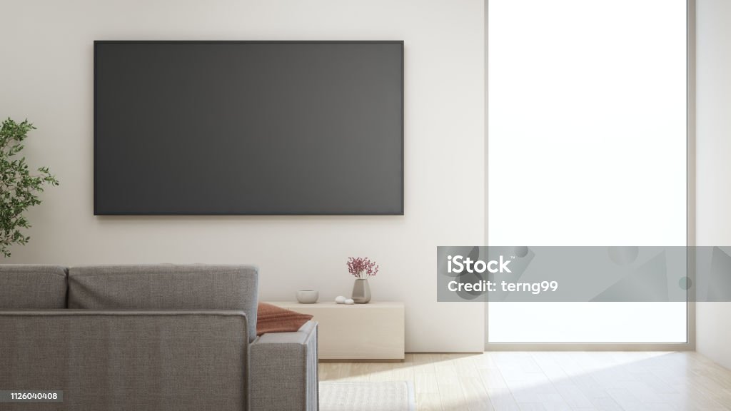 Living room of modern house with glass window and wooden floor. TV on white wall against sofa in home or villa. 3d rendering of hotel interior. Television Set Stock Photo