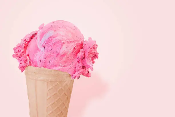 strawberry pink ice cream scoop on cone isolated on pink background with clipping path