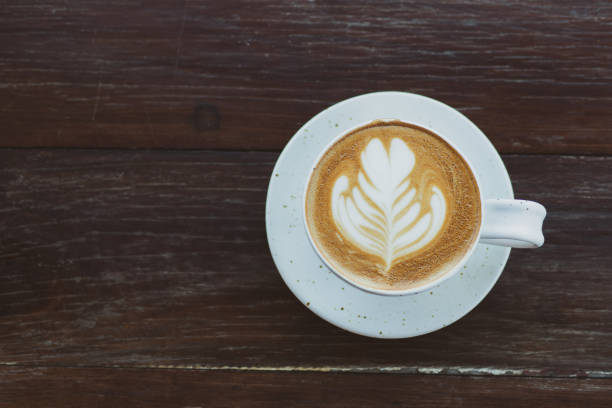 istock Hot coffee in white cup on wooden table 1126045112