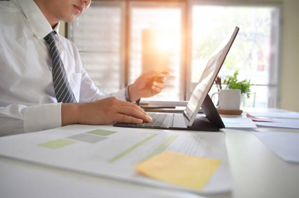 istock Businessman analysis in digital tablet on office desk. 1126045406