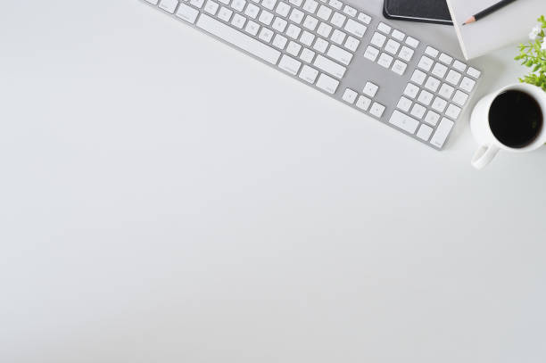 istock Flat lay top view office desk. Workspace with keyboard and office supplies with coffee on white background. 1126045489