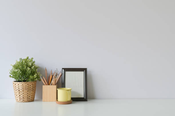 istock pencil, coffee, photo frame and plant on copy space, office desk. 1126046437