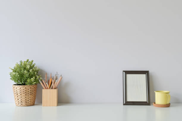 istock pencil, coffee, photo frame and plant on copy space, office desk. 1126046491