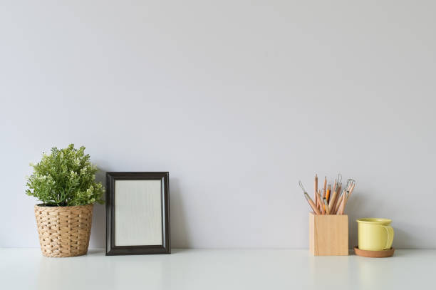 istock pencil, coffee, photo frame and plant on copy space, office desk. 1126046492