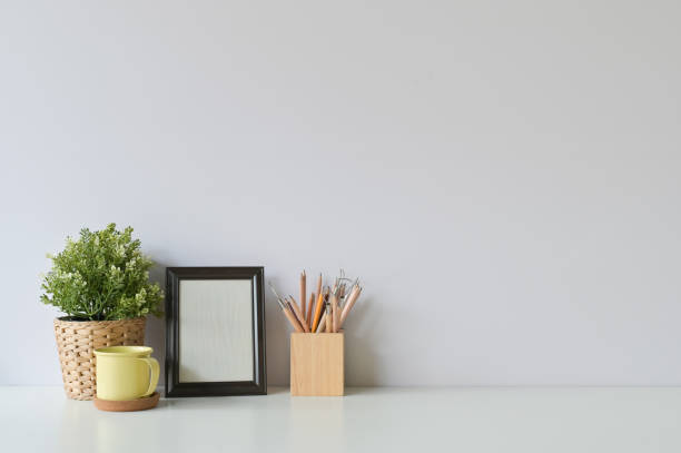 istock pencil, coffee, photo frame and plant on copy space, office desk. 1126046493