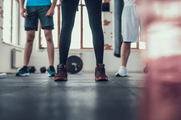 istock Bottom View. Legs Of Three Athletes On Gym Floor. 1126048666