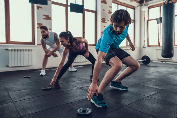 istock Athletes Touching Barbell Weight In Gym. 1126048704