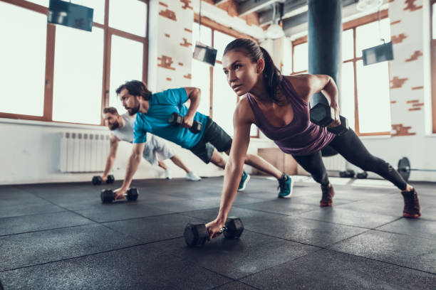 istock Athletes On The Floor. Dumbbell Lift With One Hand 1126048724