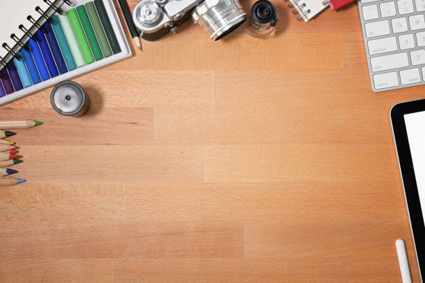 istock Graphic designer wooden desk essentials and copy space 1126049014