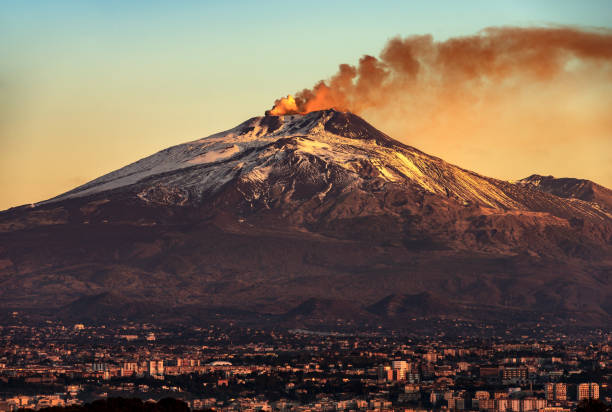 Catania and Mount Etna Volcano in Sicily Italy Mount Etna Volcano with smoke at dawn and the Catania city, Sicily island, Italy, Europe volcanic landscape stock pictures, royalty-free photos & images