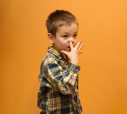 Little boy picking his nose. Funny picture of boy. Bad habit