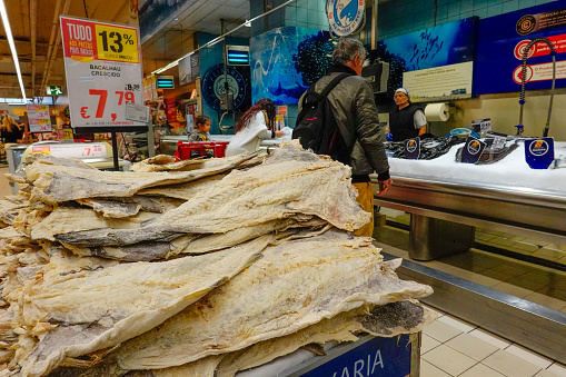 Funchal, Madeira, Portugal January 29, 2019 Shoppers in a hypermarket. A display of bacalhau, a Portuguese dried fish speciality.