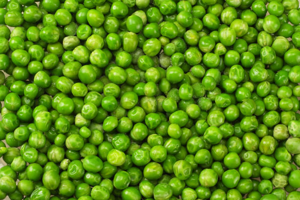 istock green peas background. green peas texture. top view 1126054870