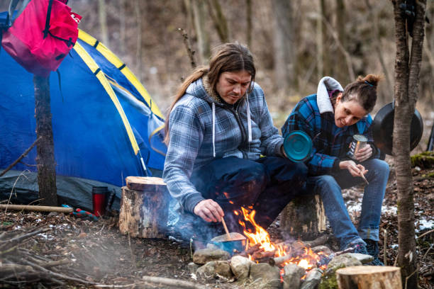 istock Mid Adult Couple Preparing Food on Campfire While Camping 1126055074