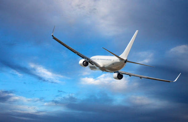 istock Aircraft is flying in blue cloudy sky 1126056052