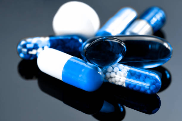Oral medications on dark background.