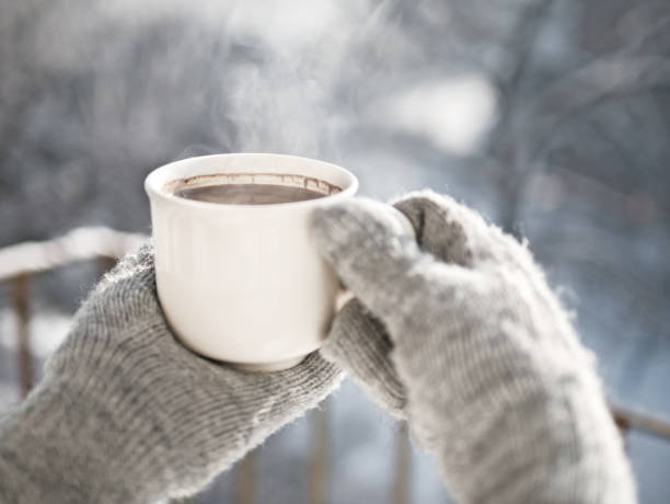 istock Woman hands holding hot cup coffee, tea 1126057153