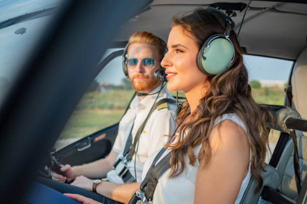 istock Smiling passenger in helicopter cockpit with headphones on 1126057232