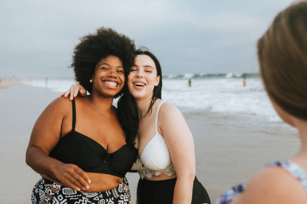 istock Cheerful beautiful plus size women at the beach 1126057347